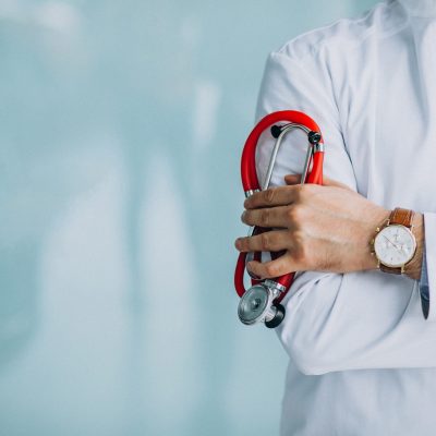 Young handsome physician in a medical robe with stethoscope Young handsome physician in a medical robe with stethoscope